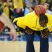 Michigan assistant coach Bacari Alexander balances a ball on his back as he goofs around during an open practice at the Georgia Dome in Atlanta on Friday, April 5, 2015. Melanie Maxwell I AnnArbor.com
